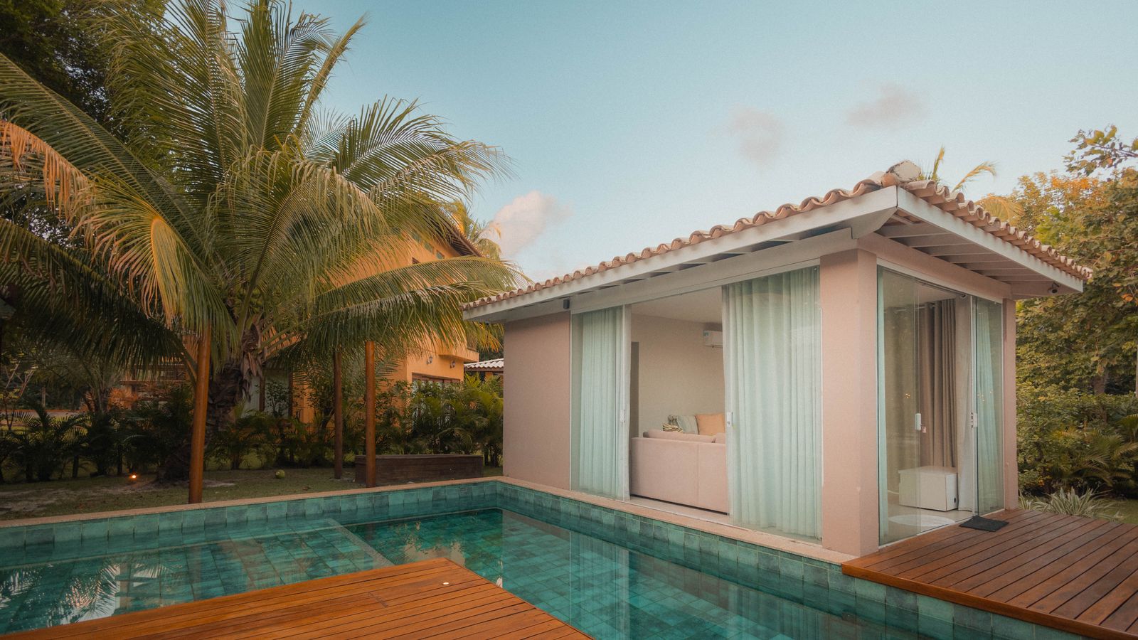 Villa pool and gardens at sunset